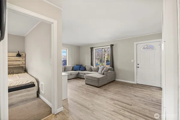 a living room with furniture and a wooden floor