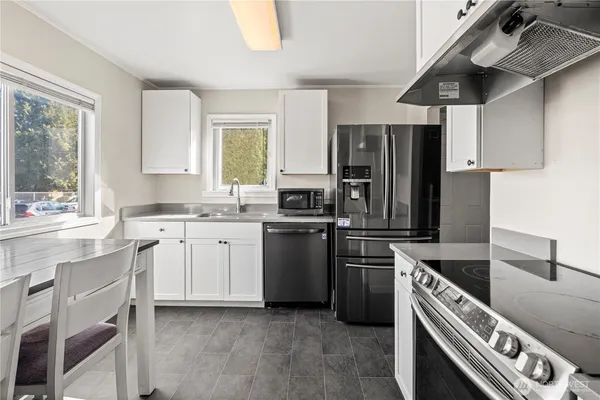a kitchen with a refrigerator sink and stove
