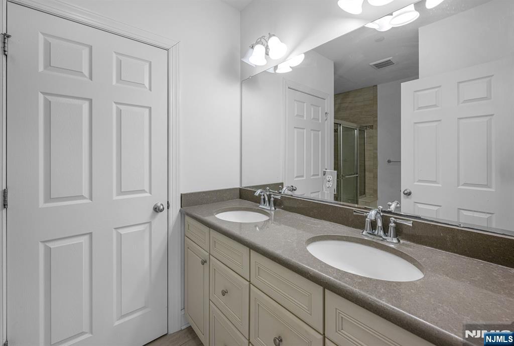 63 Autumn Way, Unit 35 Montvale, NJ 07645 - Photo 15 of 27 a bathroom with a granite countertop double vanity sink and a mirror