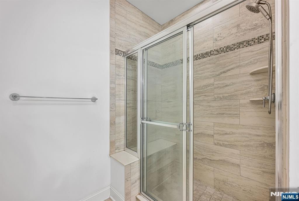 63 Autumn Way, Unit 35 Montvale, NJ 07645 - Photo 17 of 27 a bathroom with a glass shower door