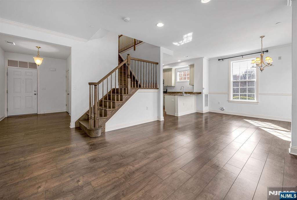 63 Autumn Way, Unit 35 Montvale, NJ 07645 - Photo 5 of 27 a view of an empty room with wooden floor and a window