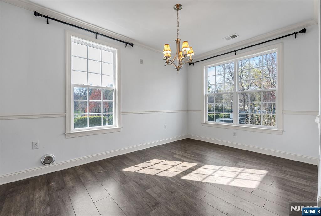 63 Autumn Way, Unit 35 Montvale, NJ 07645 - Photo 6 of 27 a view of an empty room with wooden floor and a window