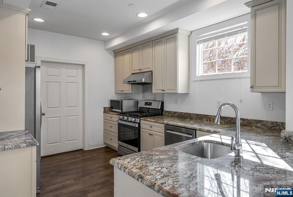 63 Autumn Way, Unit 35 Montvale, NJ 07645 - Photo 7 of 27 a kitchen with granite countertop a stove a sink and a refrigerator
