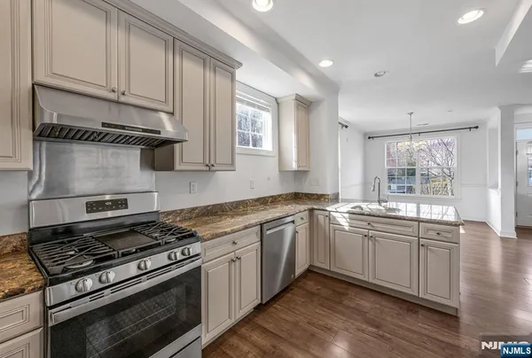 a kitchen with stainless steel appliances granite countertop a stove and a sink