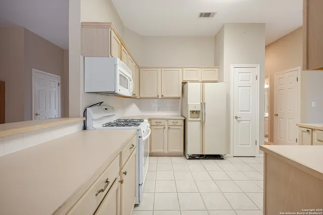 a kitchen with a stove a refrigerator and a sink