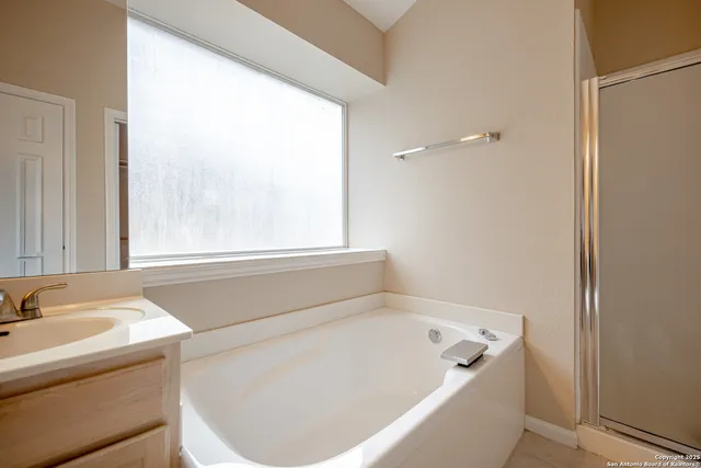 a bathroom with a bathtub and window