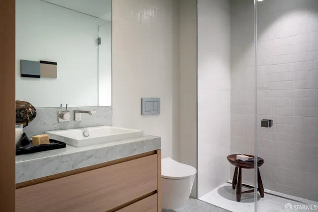 a bathroom with a sink toilet and a mirror