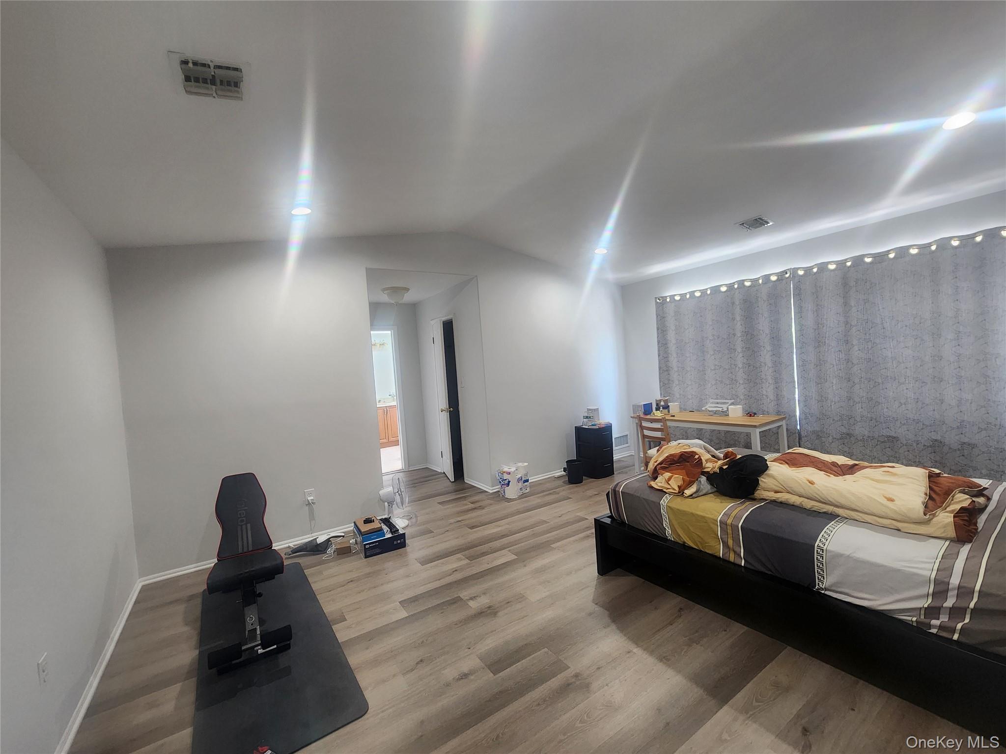 3 Arbor Field Way Lake Grove, NY 11755 - Photo 5 of 12 a bedroom with bed and a chandelier