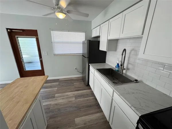 a kitchen with a stove a sink and a refrigerator