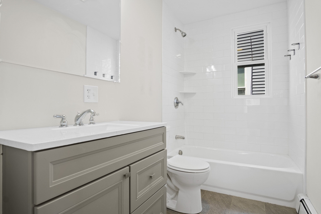 10 Redfield Street, Unit 2 Boston, MA 02122 - Photo 5 of 10 a bathroom with a sink a toilet and shower
