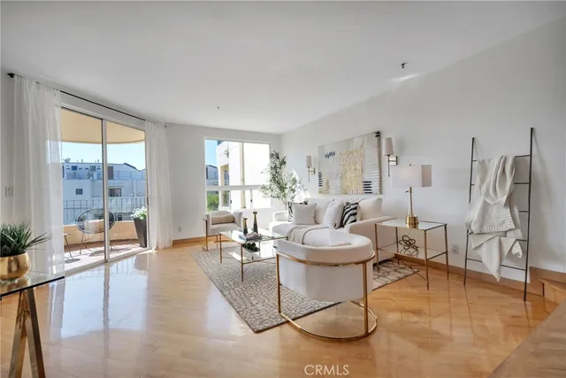 a living room with furniture a rug and a large window