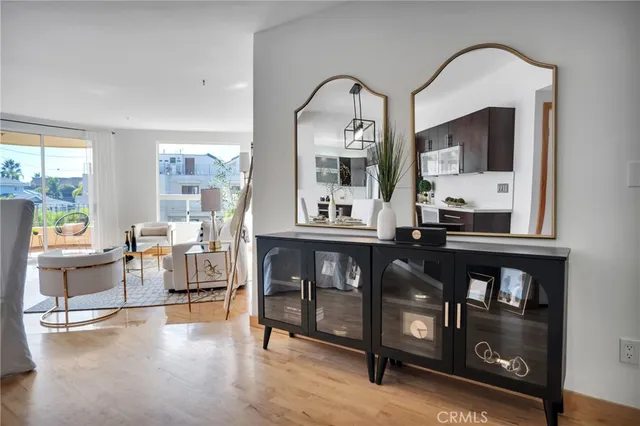 a living room with furniture and view of kitchen