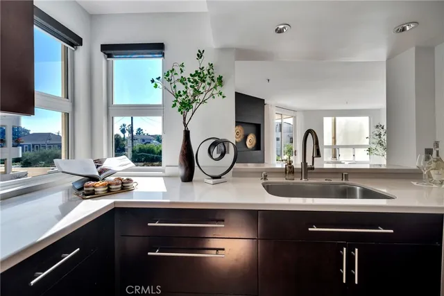 a kitchen with a sink and a clock on the wall