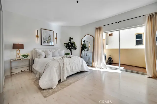 a spacious bedroom with a bed and a window