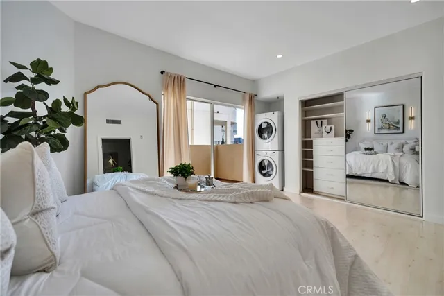 a bedroom with a large bed and a fireplace