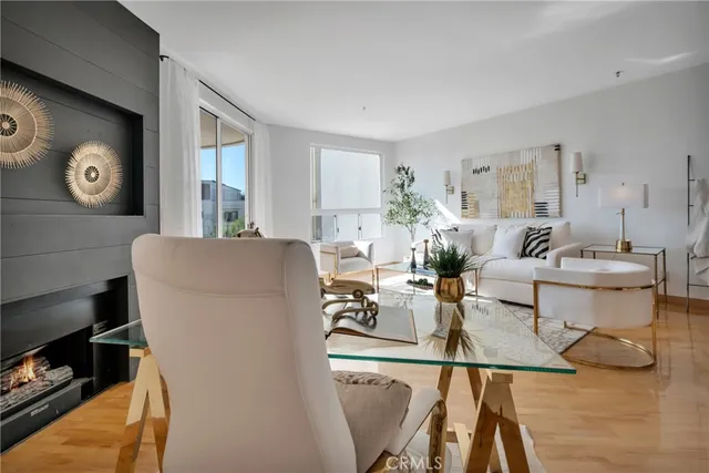 a living room with furniture a window and wooden floor