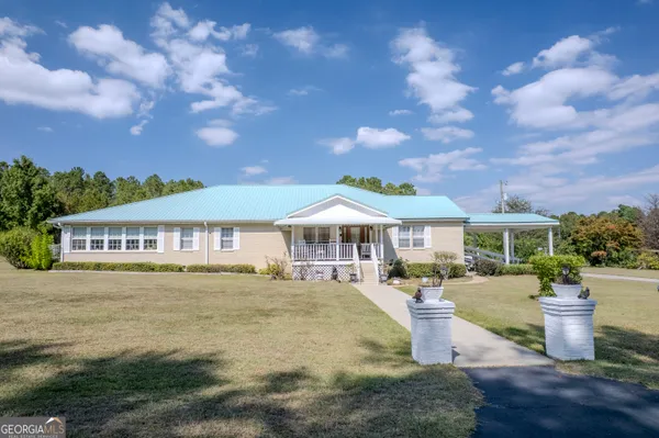 a front view of a house with a garden