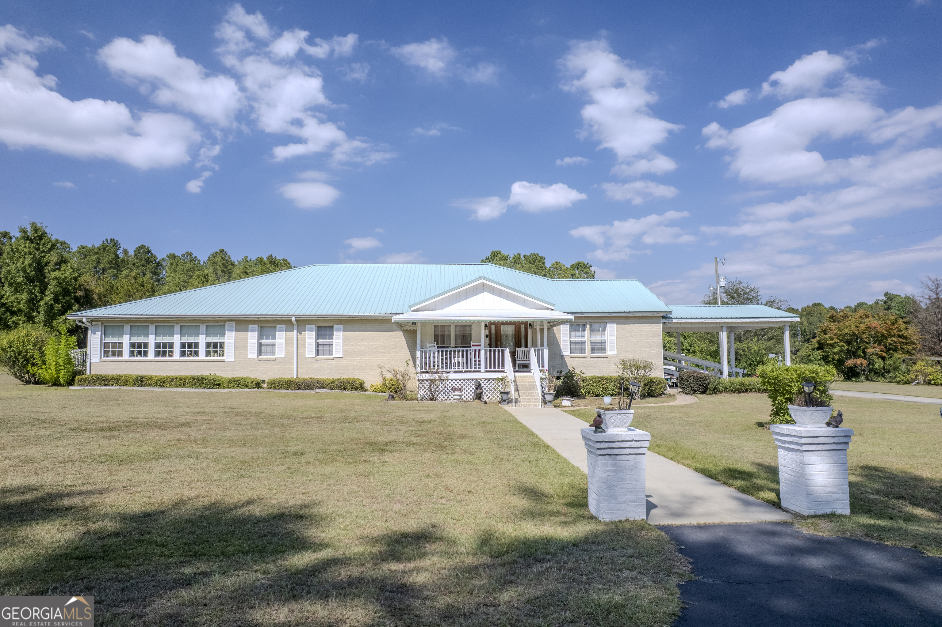 a front view of a house with a garden