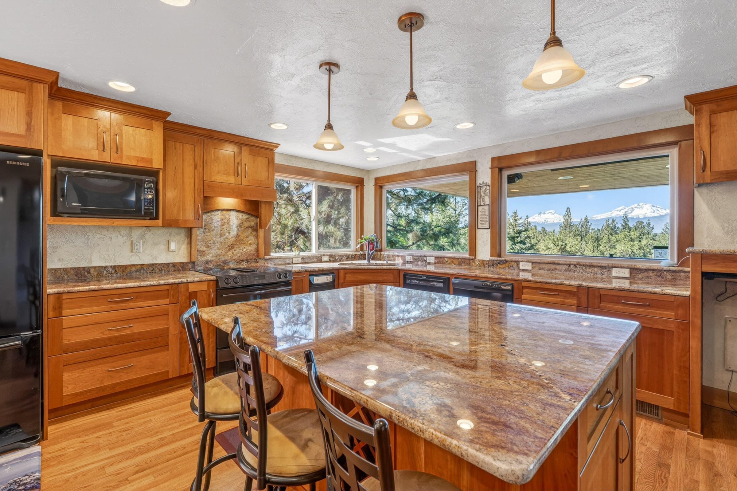 69470 Deer Ridge Road Sisters, OR 97759 - Photo 10 of 96 a dining room with granite countertop furniture and large windows