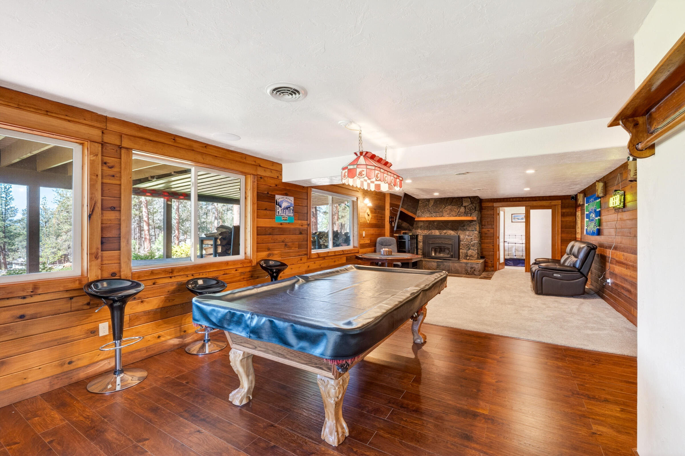 69470 Deer Ridge Road Sisters, OR 97759 - Photo 42 of 96 a living room with furniture pool table and a large window