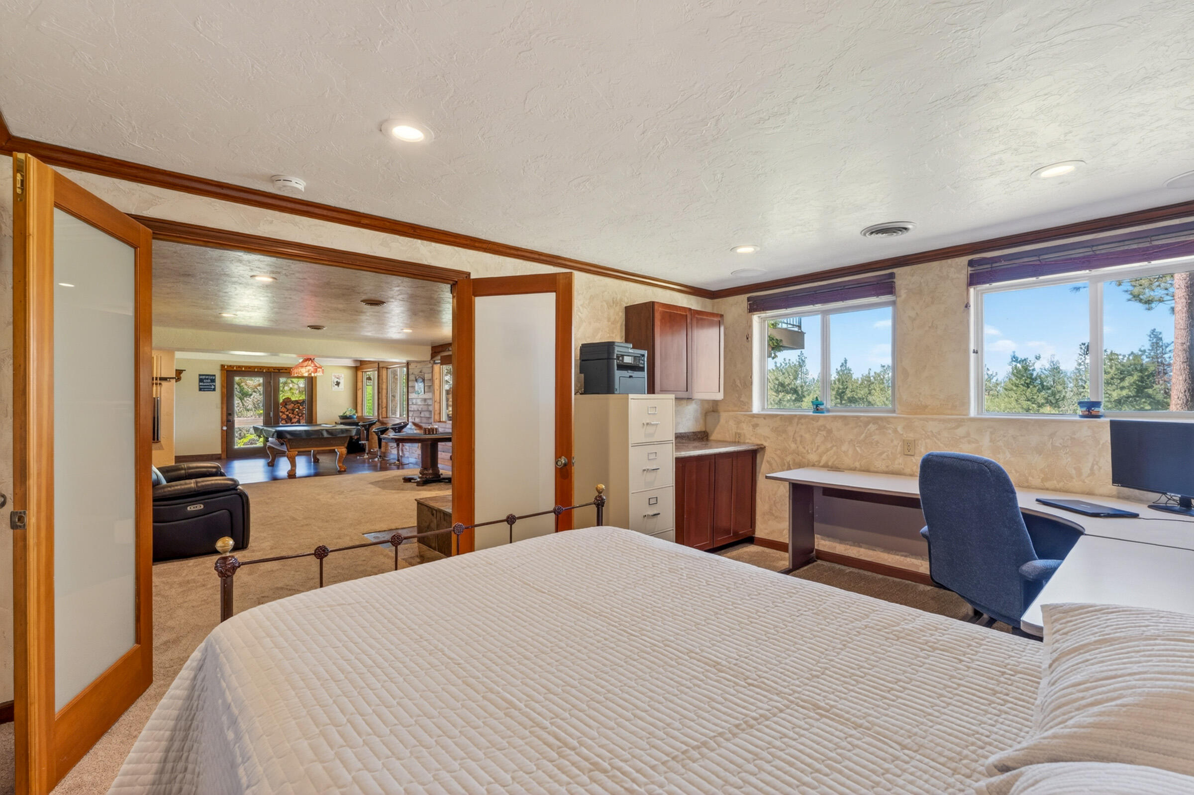 69470 Deer Ridge Road Sisters, OR 97759 - Photo 51 of 96 a bedroom with a large bed and a large window
