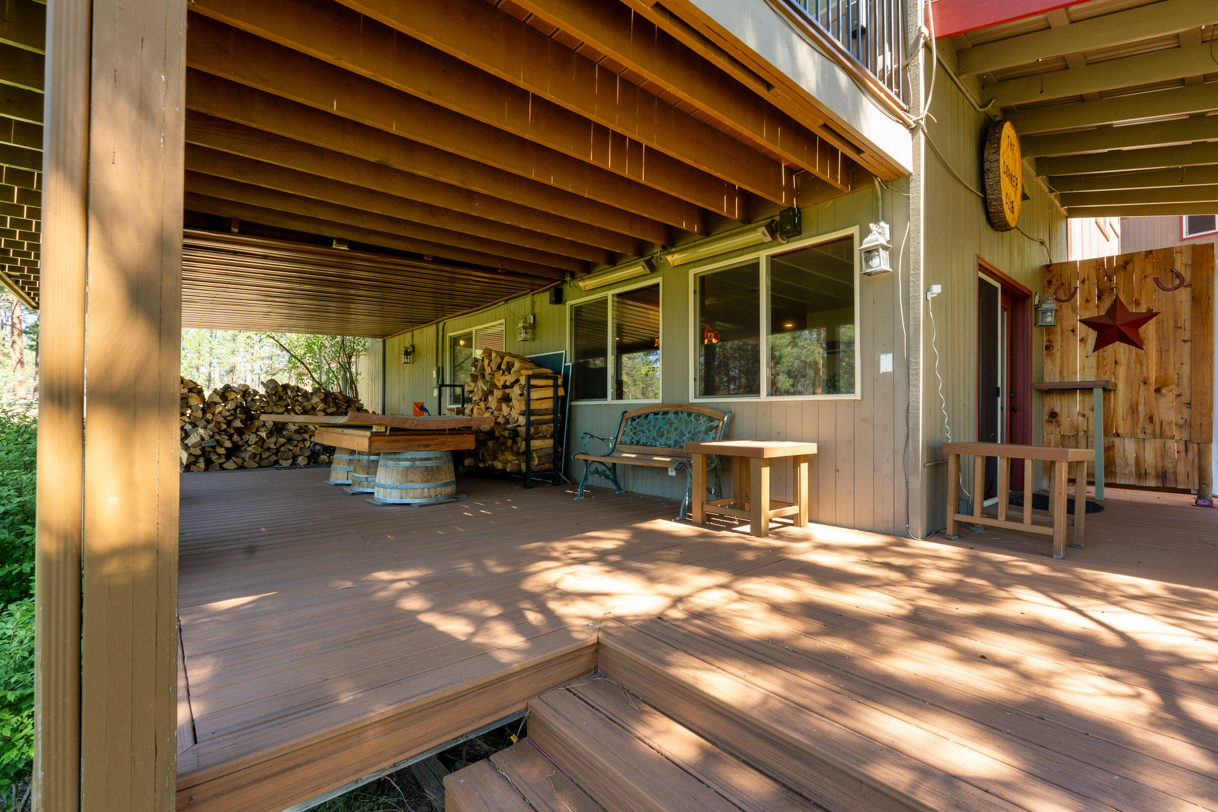 69470 Deer Ridge Road Sisters, OR 97759 - Photo 71 of 96 a view of a patio with table and chairs near a barbeque