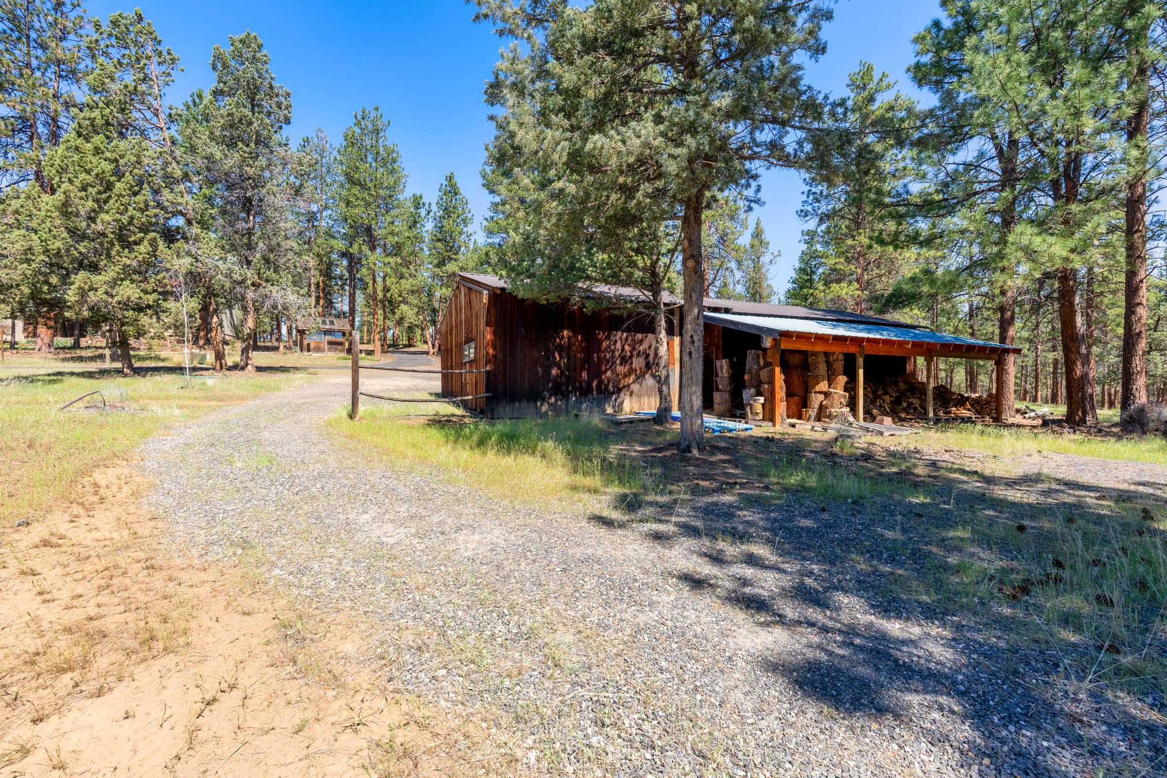 69470 Deer Ridge Road Sisters, OR 97759 - Photo 78 of 96 a view of a house with a yard and large tree