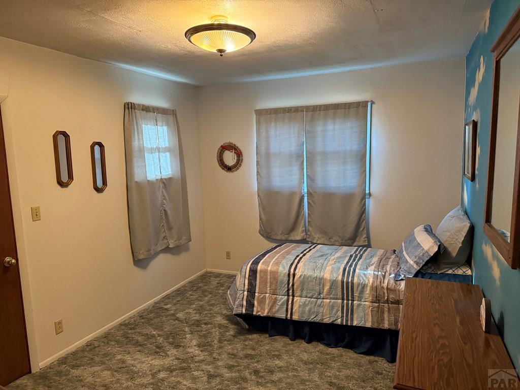 65281 Highway 50 Fowler, CO 81039 - Photo 11 of 16 a bedroom with a bed and lamp