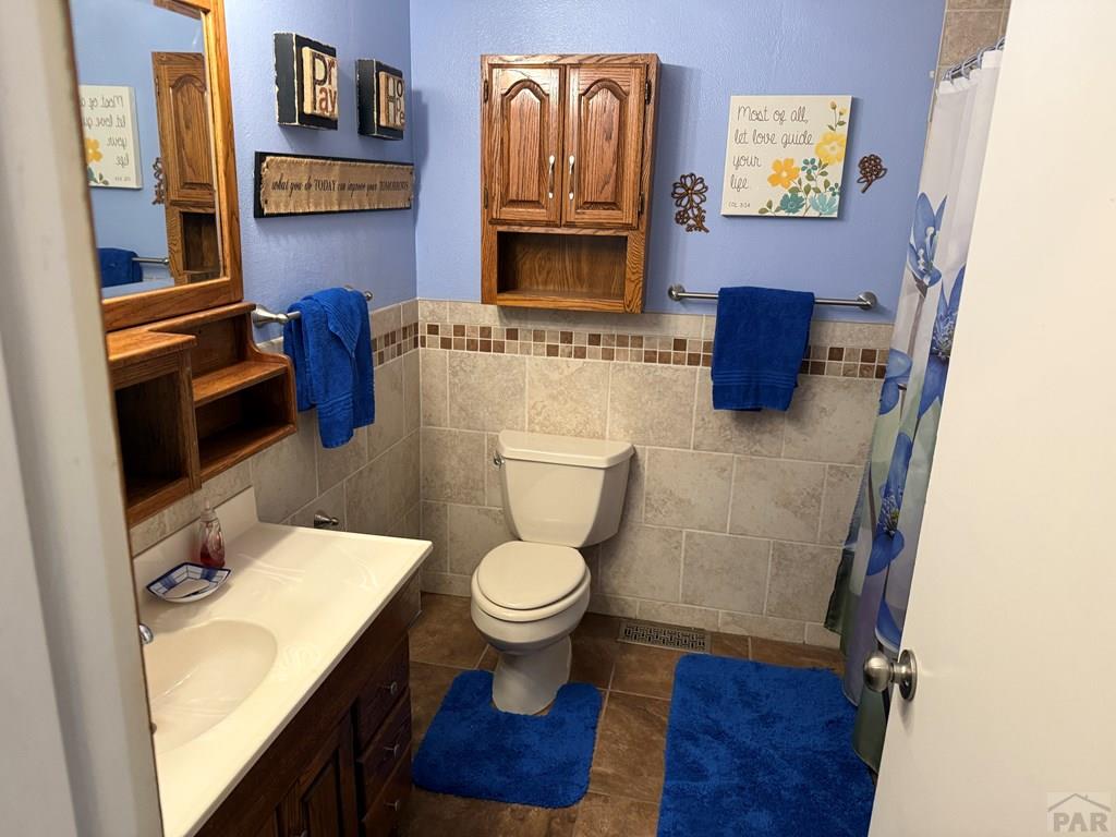 65281 Highway 50 Fowler, CO 81039 - Photo 12 of 16 a bathroom with a toilet a sink and mirror