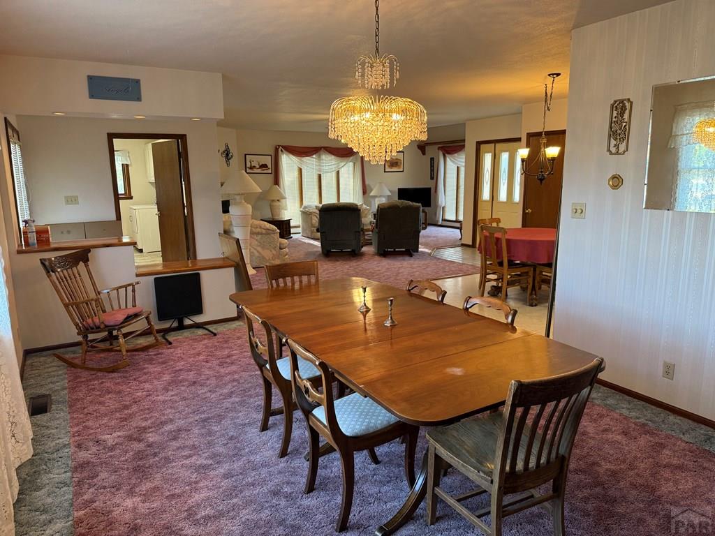 65281 Highway 50 Fowler, CO 81039 - Photo 13 of 16 a view of a dining room with furniture and a chandelier