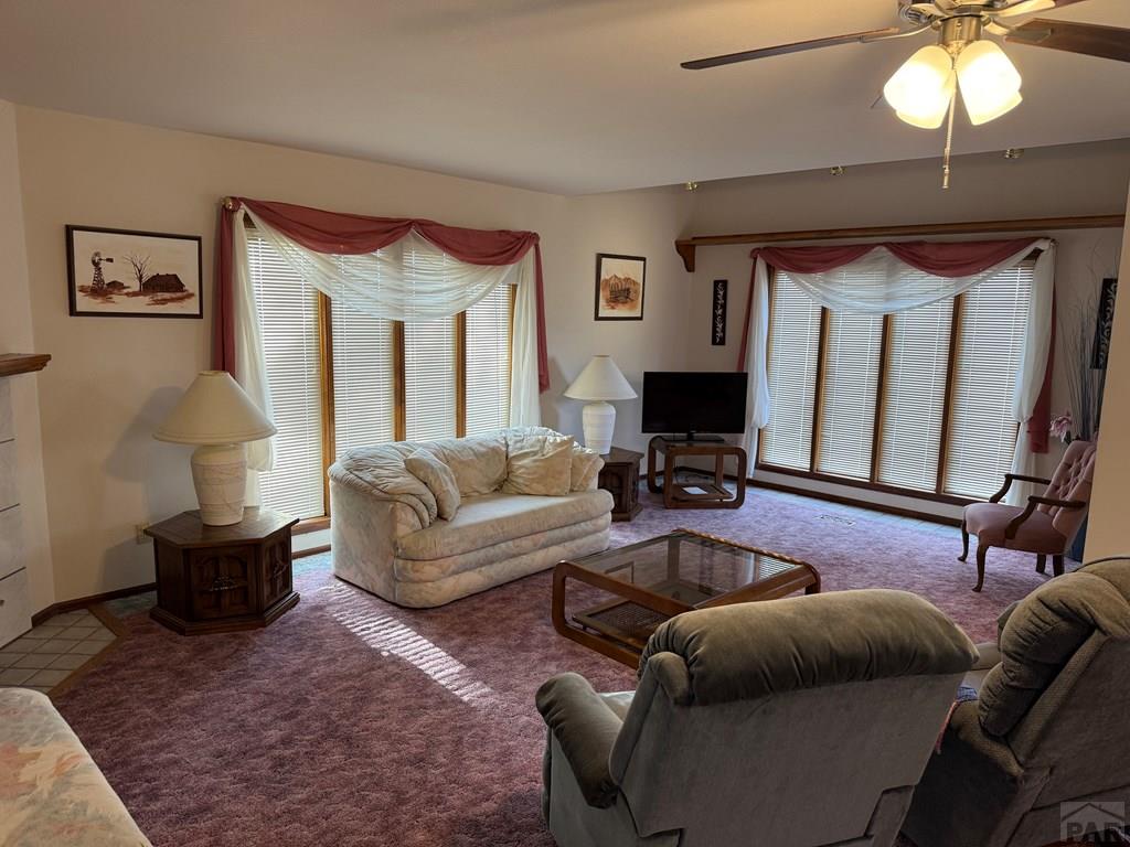 65281 Highway 50 Fowler, CO 81039 - Photo 15 of 16 a living room with furniture a lamp and a chandelier