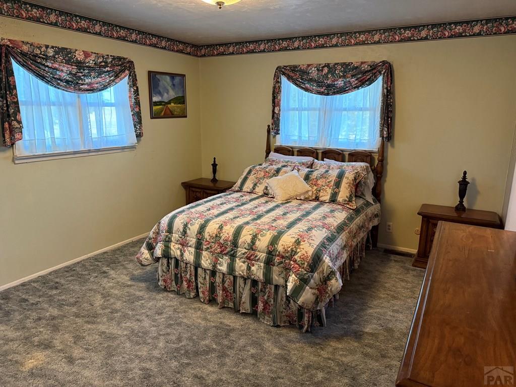 65281 Highway 50 Fowler, CO 81039 - Photo 8 of 16 a bed sitting in a bedroom next to a window