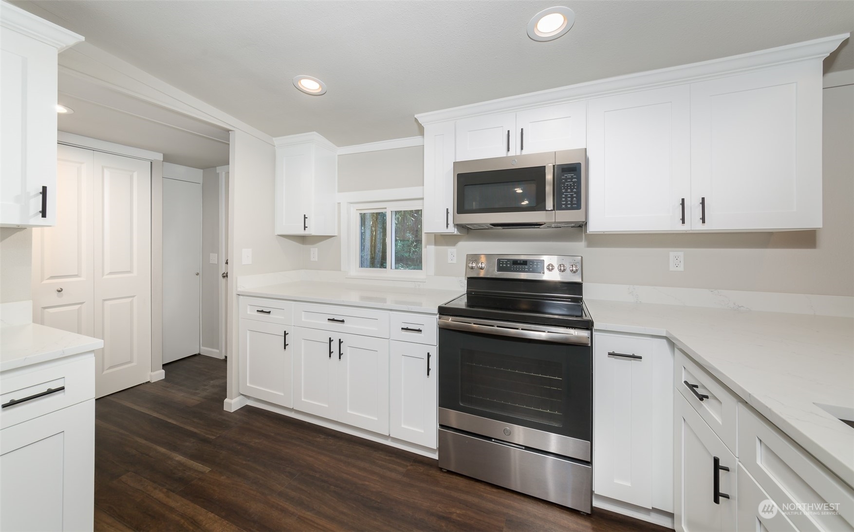 3429 Robe Menzel Road Granite Falls, WA 98252 - Photo 8 of 40 a kitchen with cabinets stainless steel appliances and wooden floor