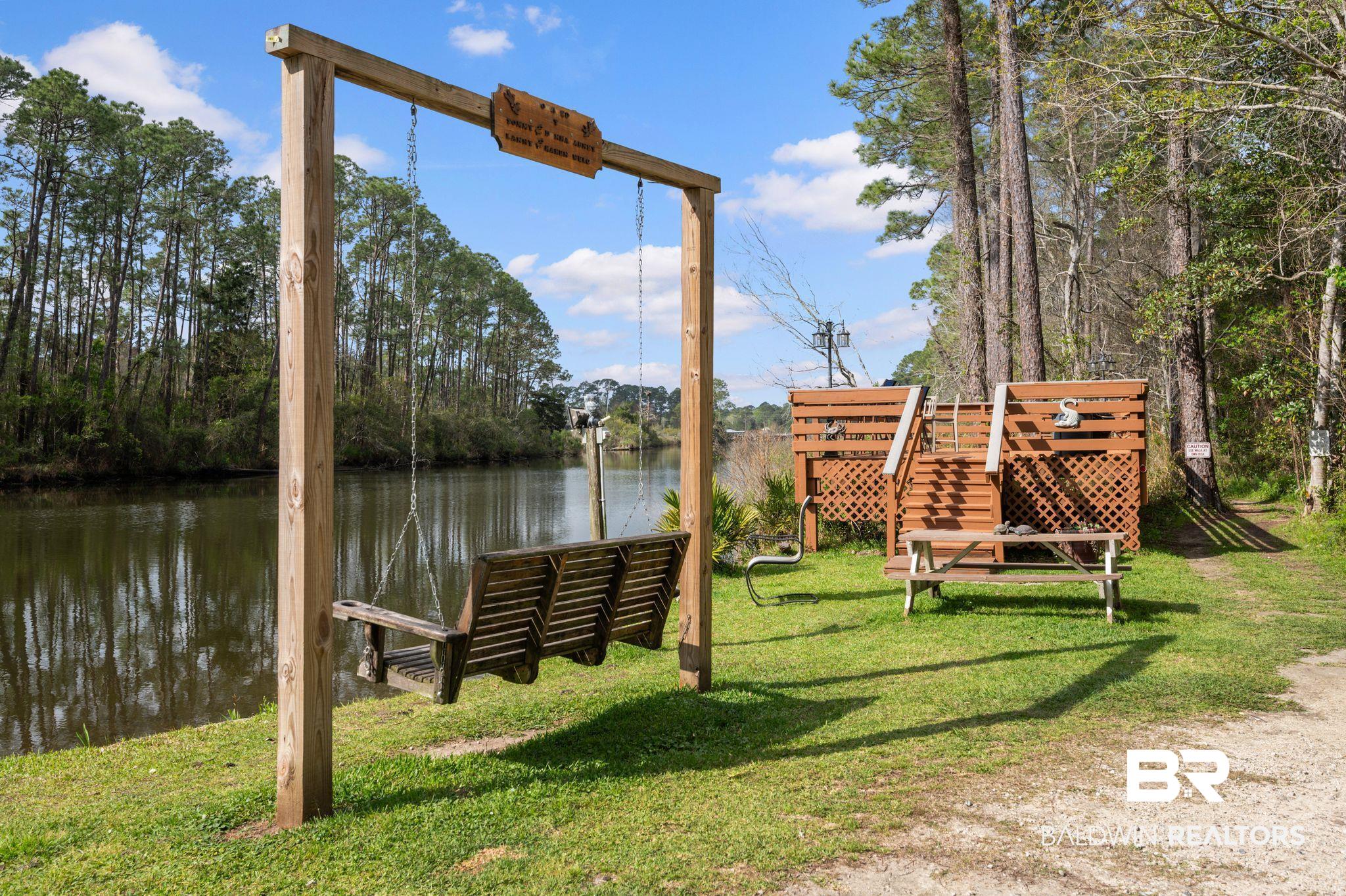 24711 County Road 20, Unit A11 Elberta, AL 36530 - Photo 29 of 35 Dock area featuring a lawn and a water view
