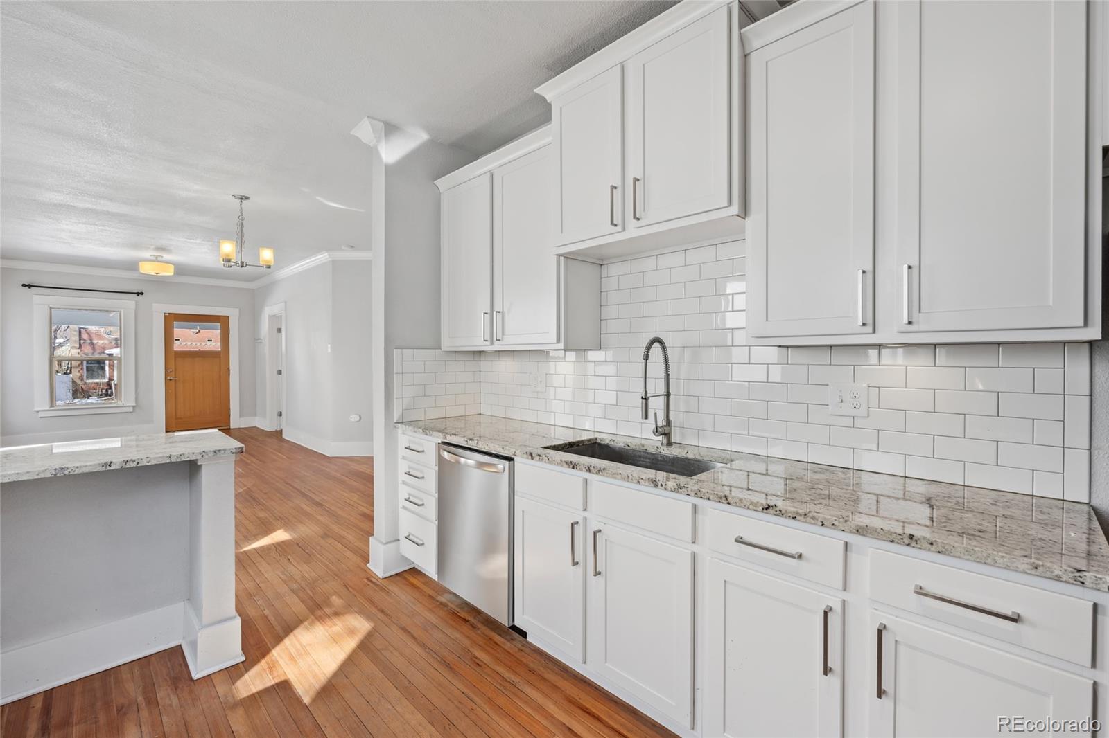 3340 Decatur Street Denver, CO 80211 - Photo 11 of 29 a kitchen with granite countertop white cabinets and white appliances