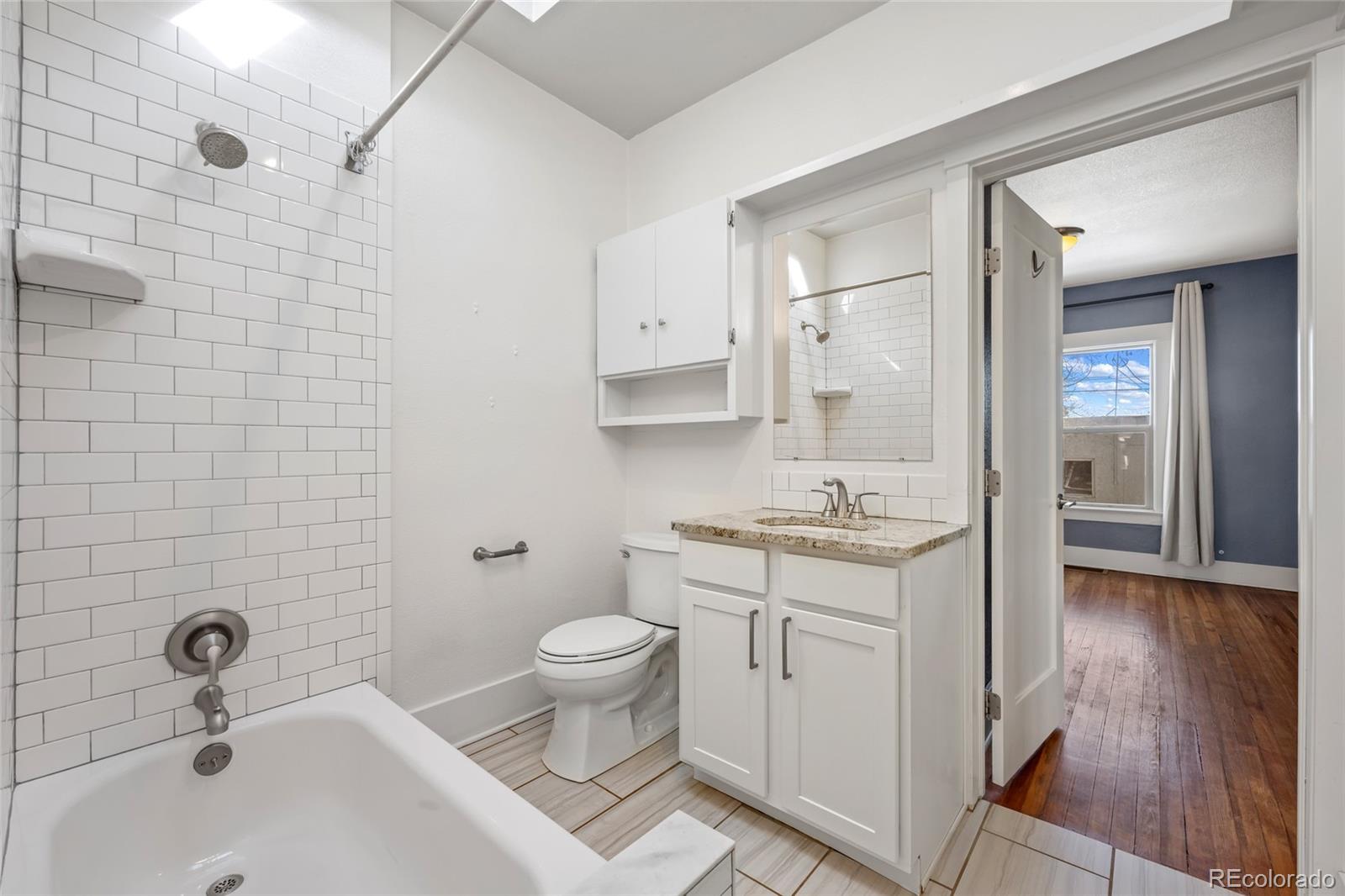 3340 Decatur Street Denver, CO 80211 - Photo 16 of 29 a bathroom with a sink a toilet and shower