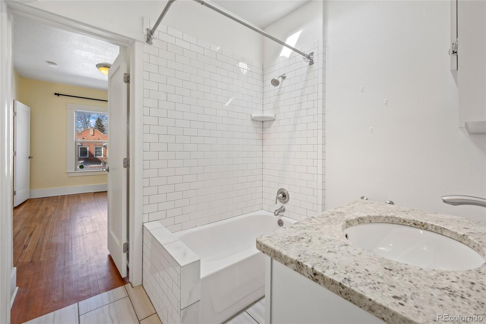 3340 Decatur Street Denver, CO 80211 - Photo 17 of 29 a bathroom with a sink and a bathtub