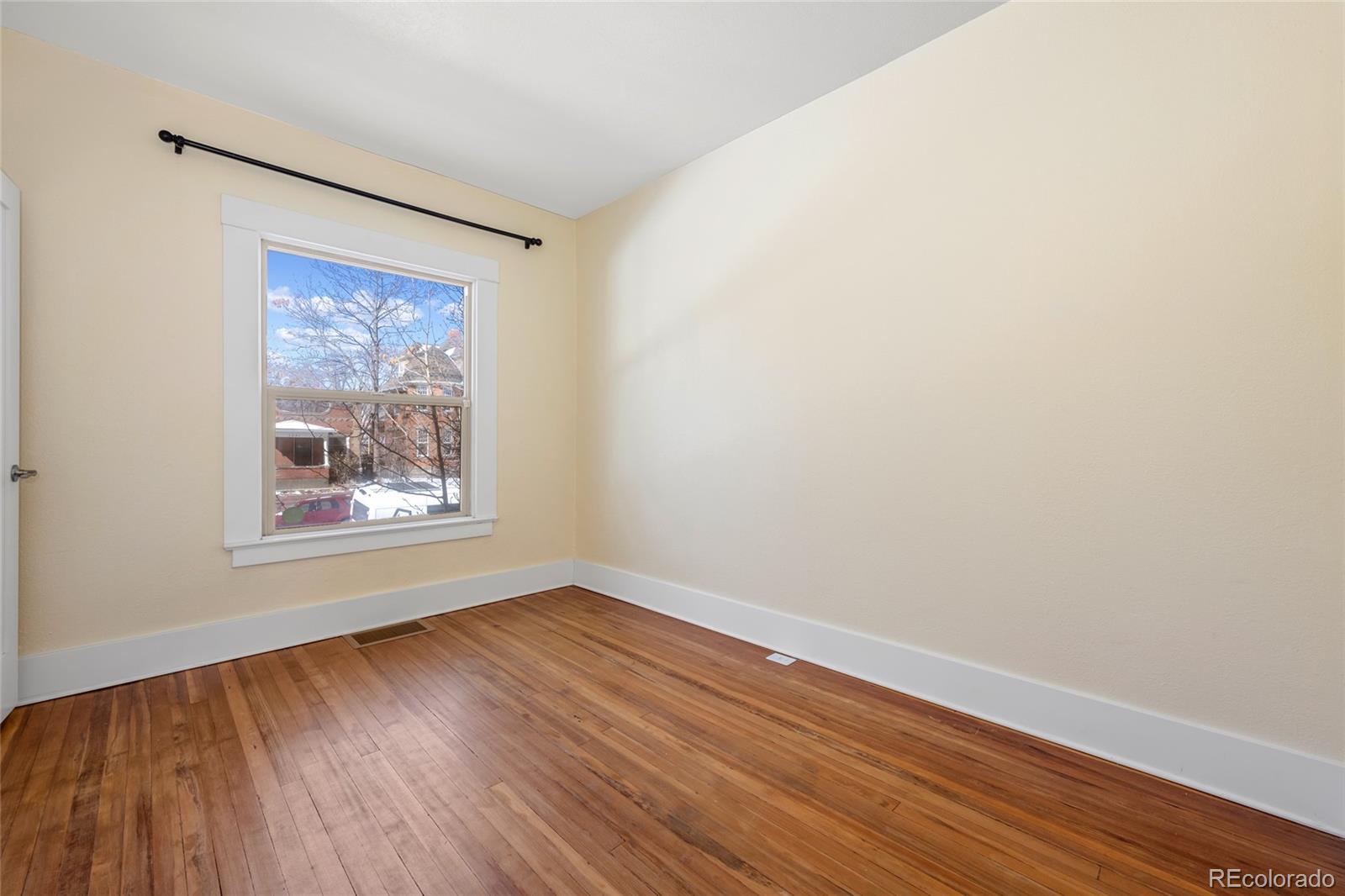 3340 Decatur Street Denver, CO 80211 - Photo 20 of 29 a view of an empty room with wooden floor and a window