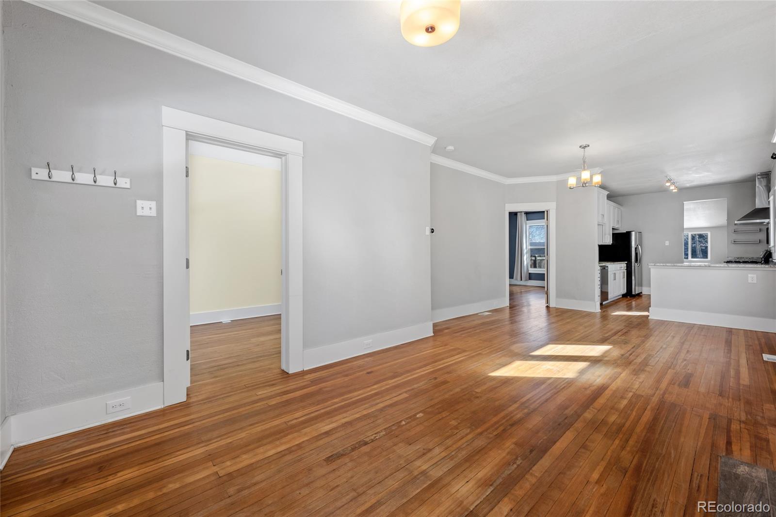 3340 Decatur Street Denver, CO 80211 - Photo 6 of 29 a view of a big room with wooden floor and a kitchen