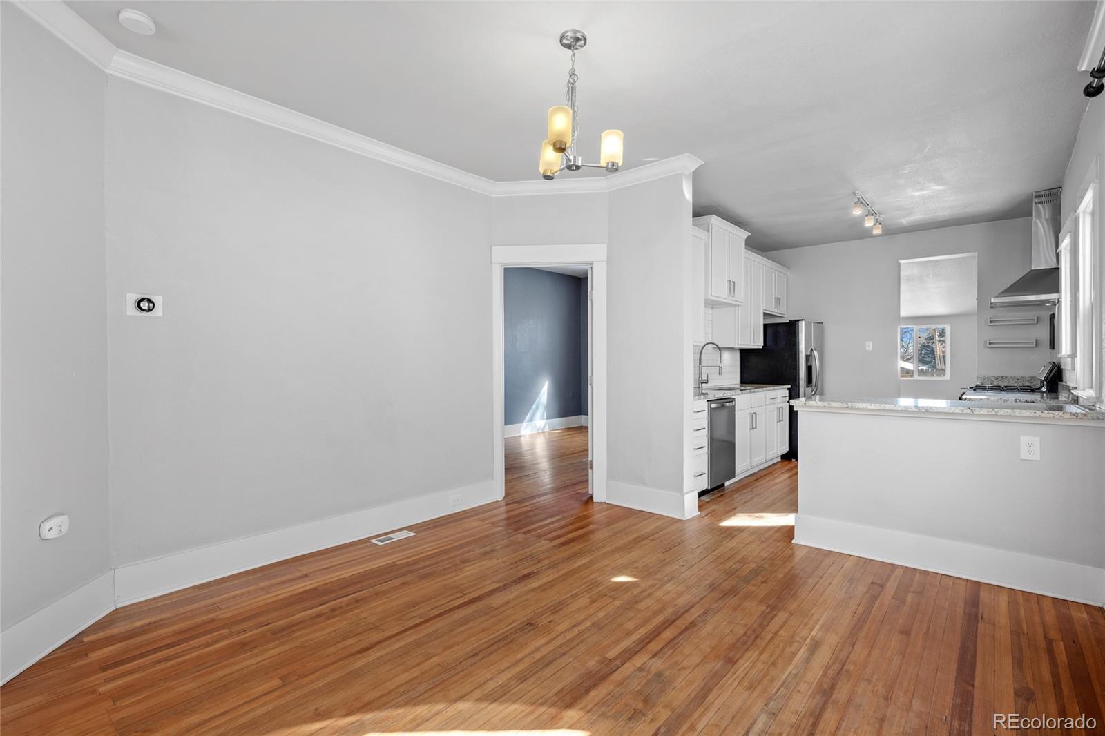 3340 Decatur Street Denver, CO 80211 - Photo 7 of 29 a view of a kitchen with wooden floor and a kitchen