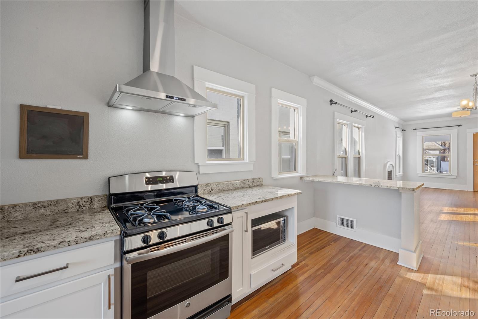3340 Decatur Street Denver, CO 80211 - Photo 8 of 29 a kitchen with granite countertop a stove and a wooden floors