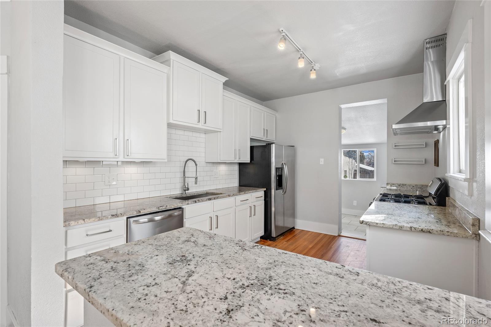 3340 Decatur Street Denver, CO 80211 - Photo 9 of 29 a kitchen with stainless steel appliances granite countertop a sink stove and refrigerator