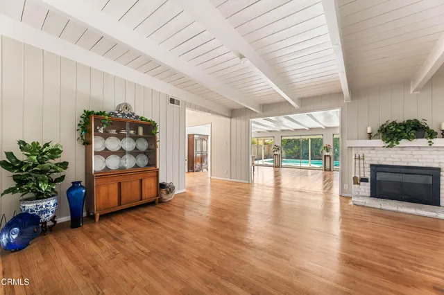 a living room with furniture a flat screen tv and a large window