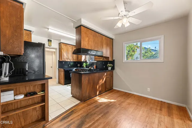a dining room with furniture a window and a kitchen view