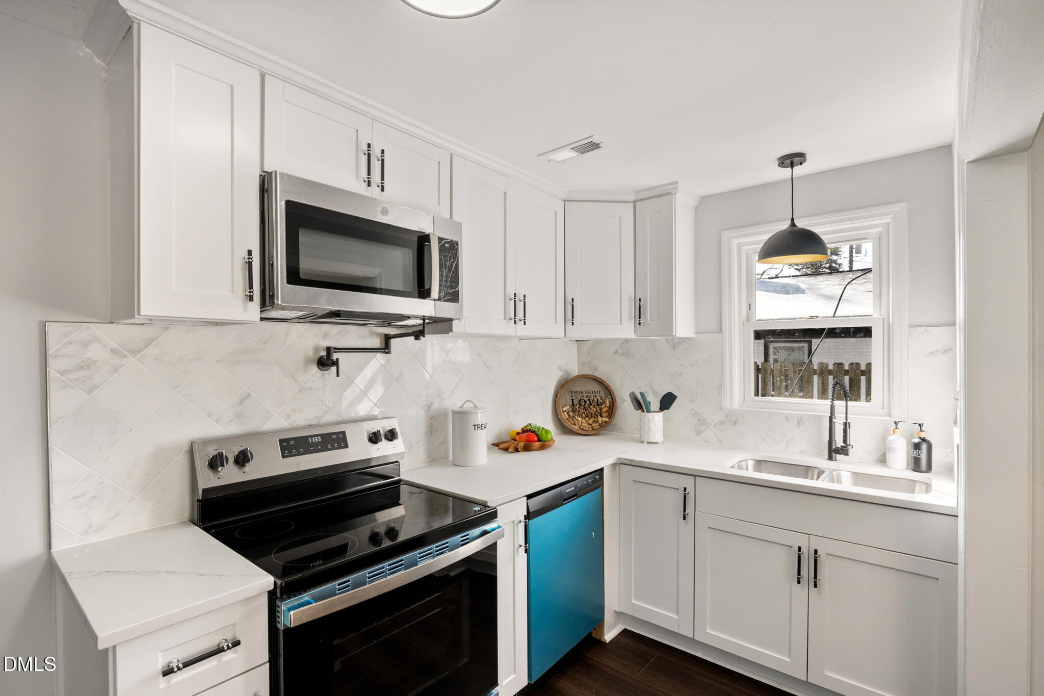 2705 Broad Street Durham, NC 27704 - Photo 13 of 33 a kitchen with stainless steel appliances a stove a sink and a microwave
