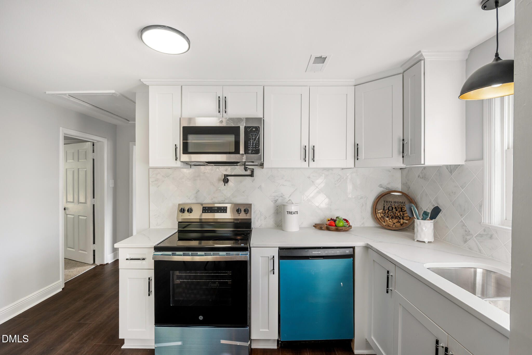 2705 Broad Street Durham, NC 27704 - Photo 15 of 33 a kitchen with a sink a stove and microwave