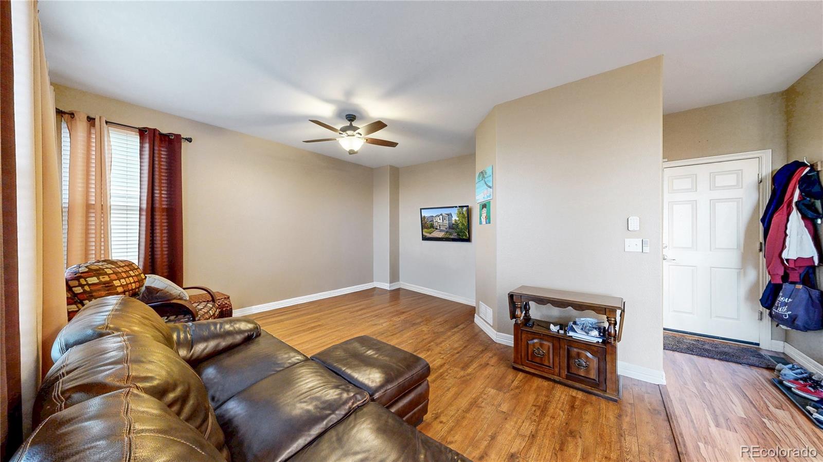 16159 Randolph Place Denver, CO 80239 - Photo 11 of 37 a living room with furniture and a flat screen tv