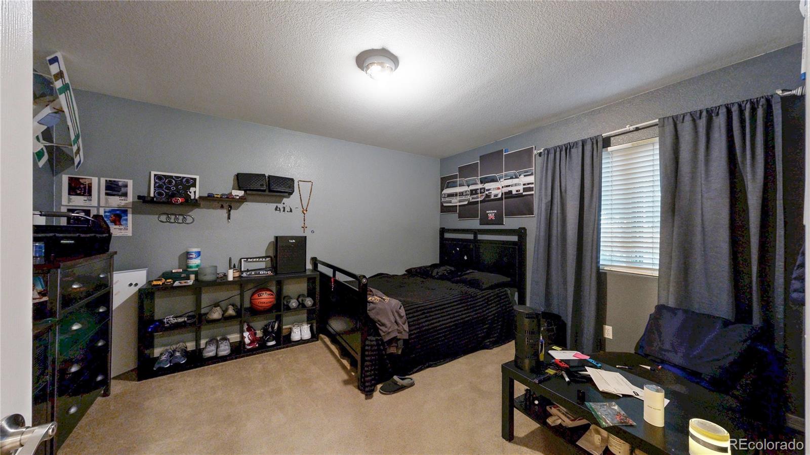 16159 Randolph Place Denver, CO 80239 - Photo 12 of 37 a bedroom with bed and a window