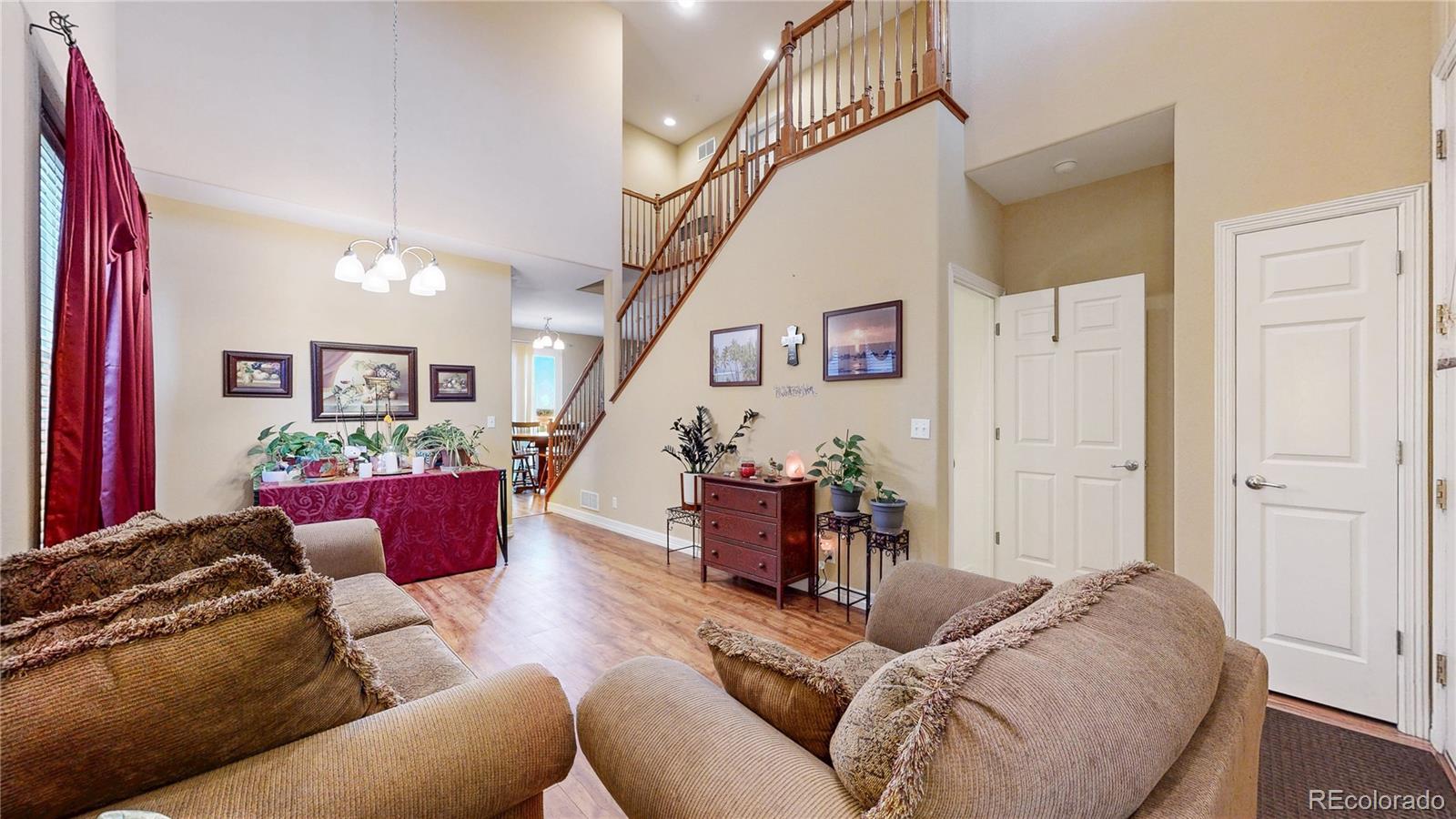 16159 Randolph Place Denver, CO 80239 - Photo 2 of 37 a living room with furniture and a wooden floor