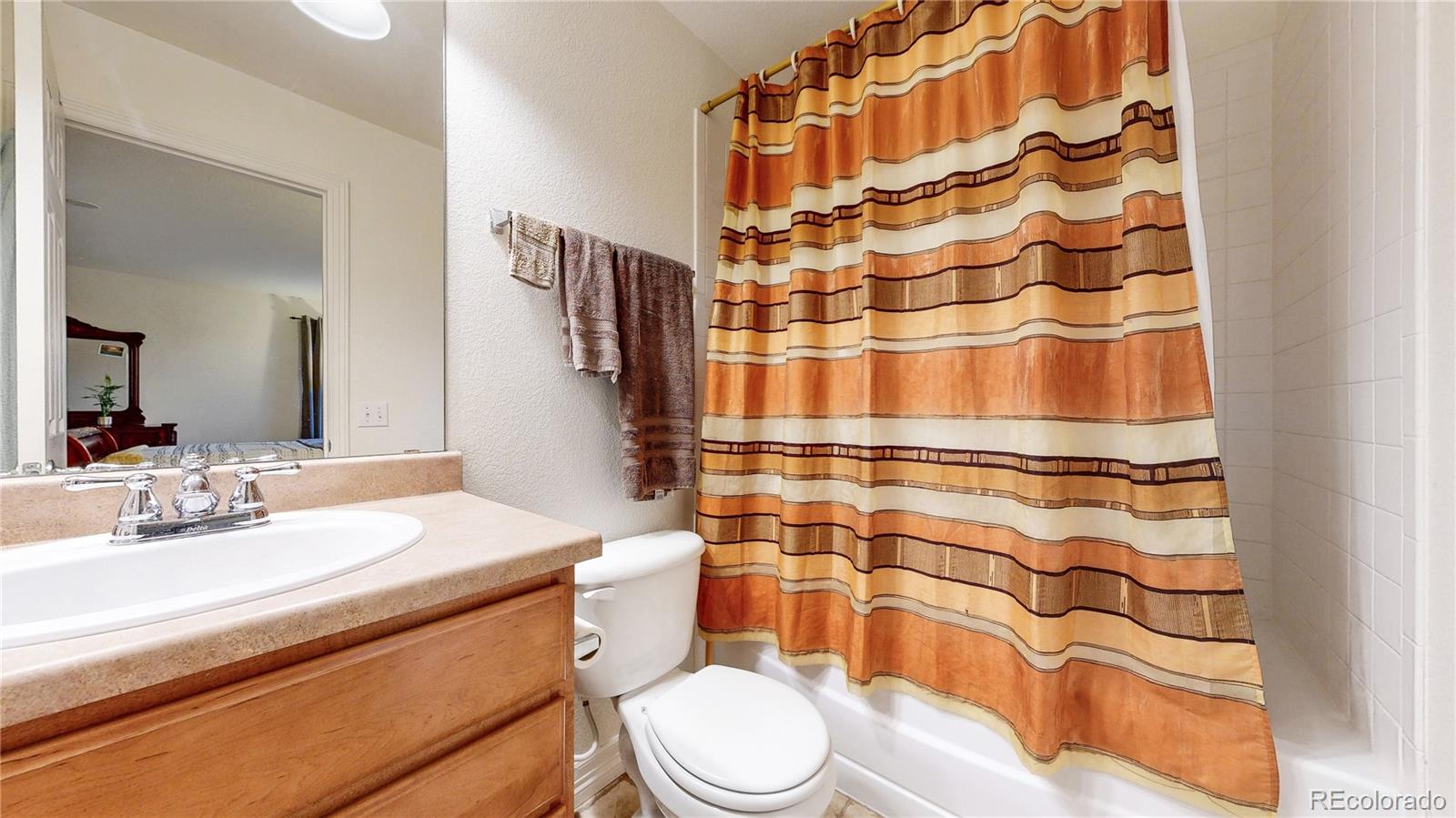 16159 Randolph Place Denver, CO 80239 - Photo 21 of 37 a bathroom with a sink toilet and shower